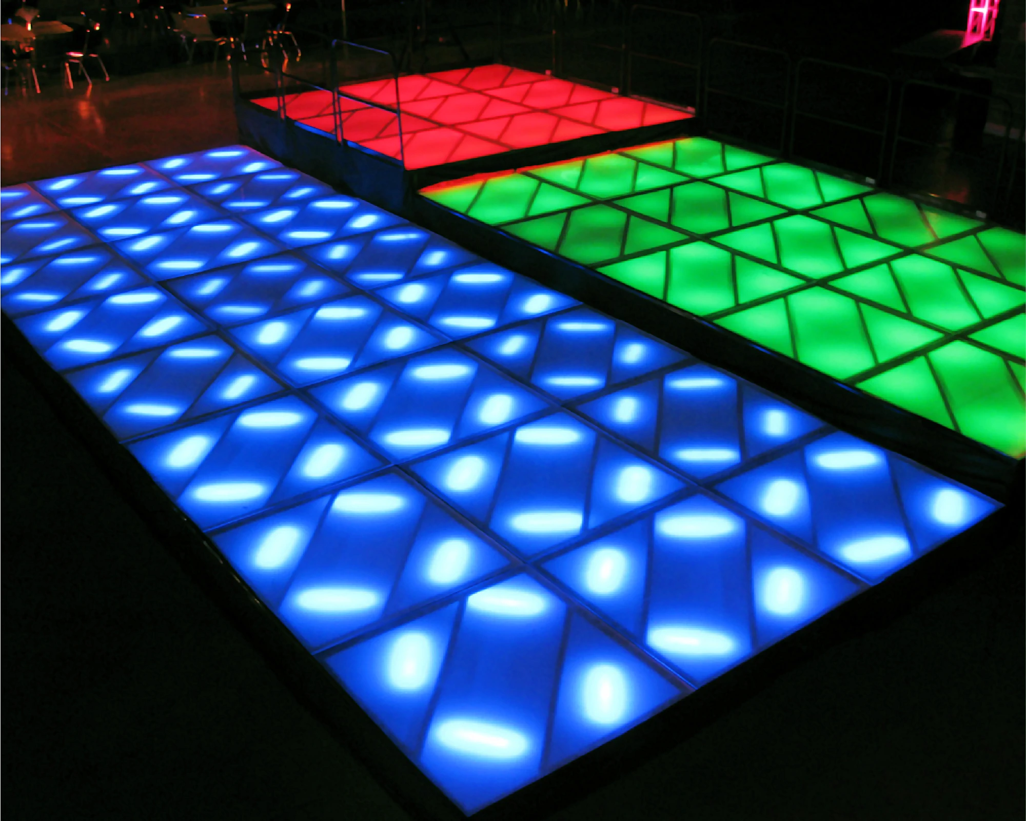 Blue lighted floor with a step up to a green lighted floor and another step up to a red lighted floor.